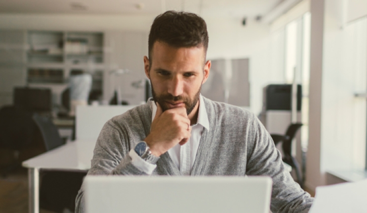 person in office viewing laptop