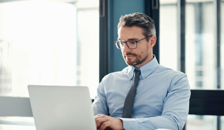 person sitting down viewing laptop